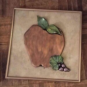 framed metallic apple art on tile